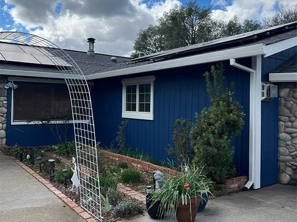 Exterior house painting in El Dorado County Placer County by Dowell's Painting Freshly painted home exterior with blue siding and white trim